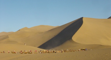 huge sand dunes and camel caravan on Silk Road, China