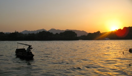 Hangzhou River Hangzhou River with fisherman at sunset